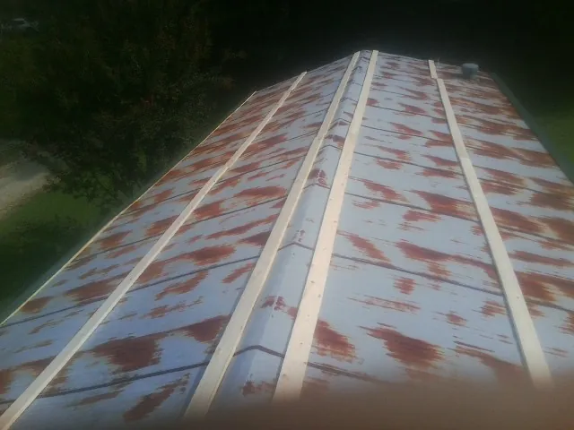 Rusted metal roof panels with new wood purlins before replacement — Storm Damage Roof Repair in Peotone by Roofing Brothers