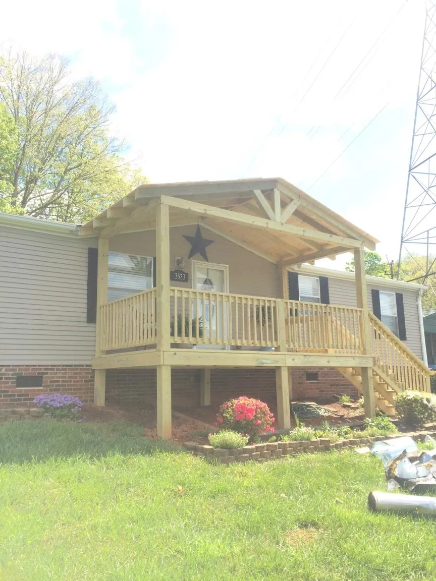 New gabled porch roof and deck railing added to a ranch home in Peotone